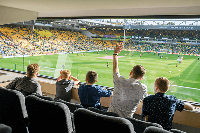 A family watching the game from the Top of the Terrace lounge